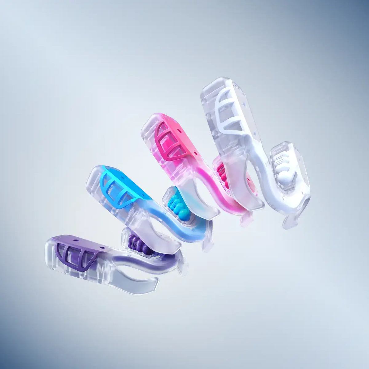 Showcase of each color of the RX1 Recovery Mouthpiece in sleep, currently offered in purple, pink, blue and white.